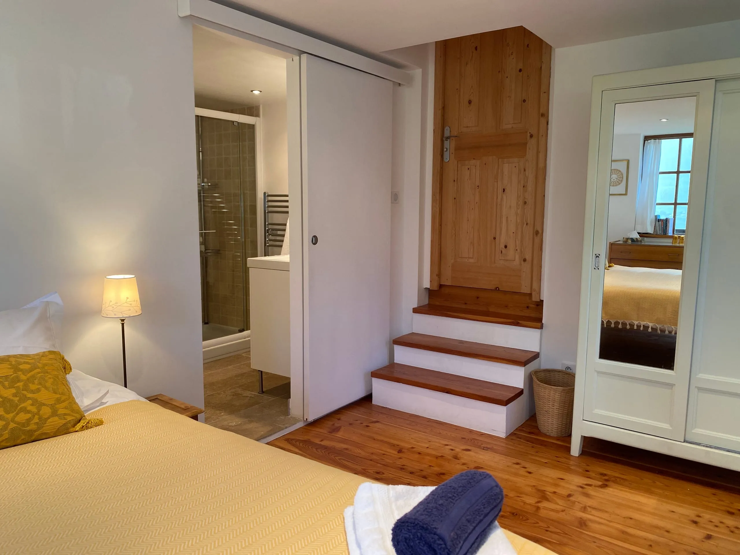 Bedroom two made up as a king-size, its ensuite behind the sliding door